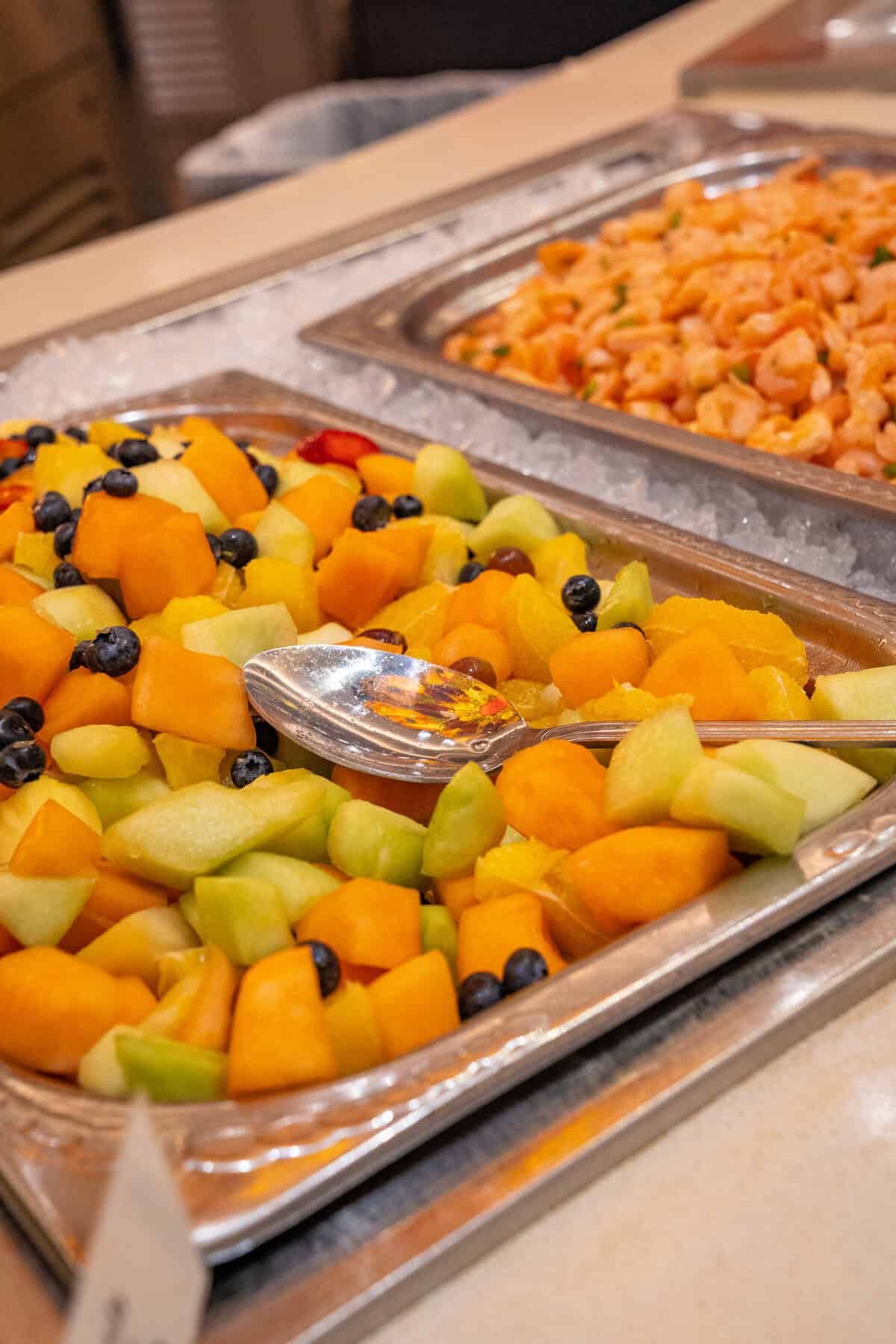 a trays of fruit and shrimp