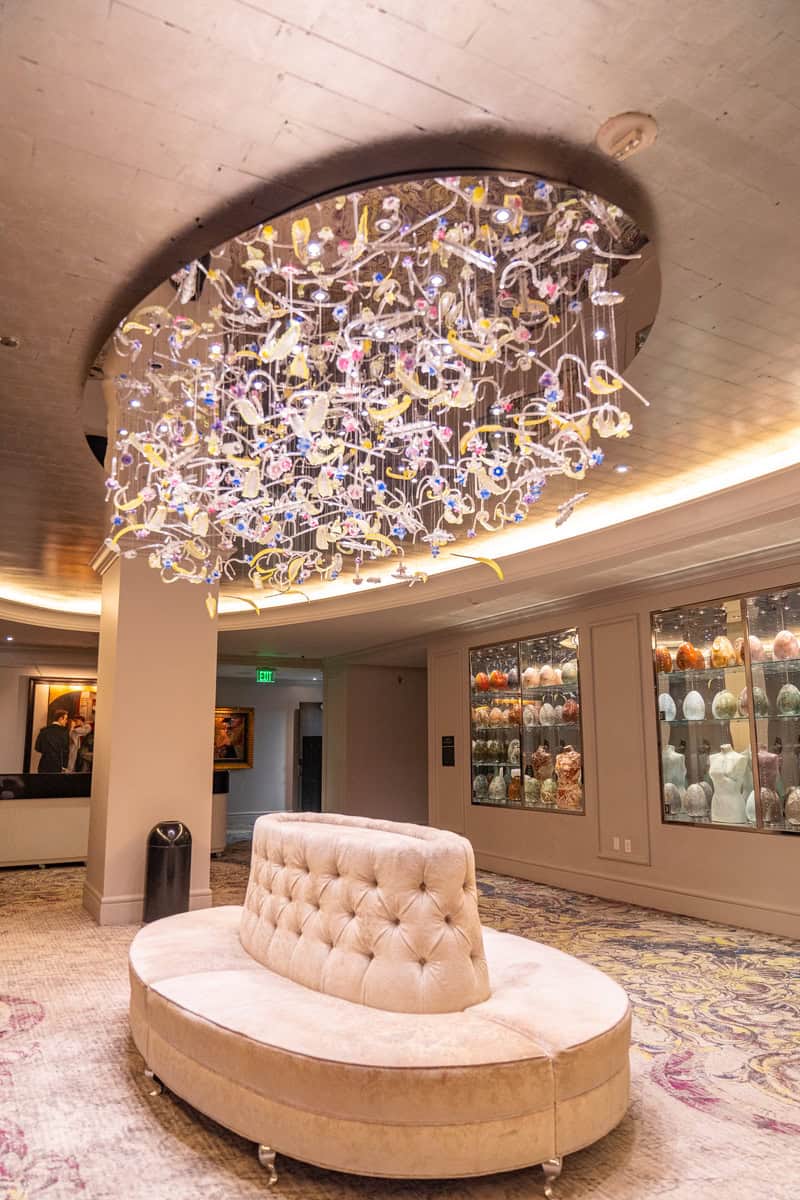 legant hotel lobby with a grand chandelier hanging from the ceiling.