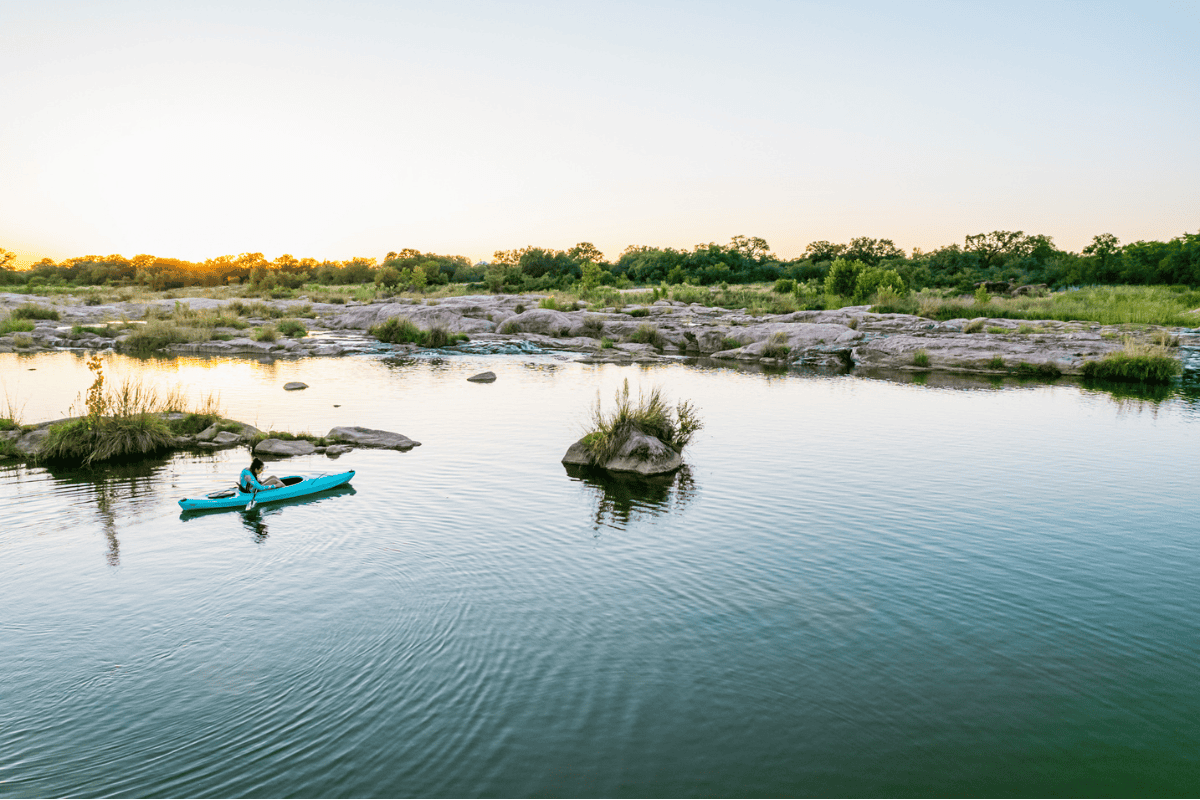 Tranquil scene of a woman in a kayak, gliding 