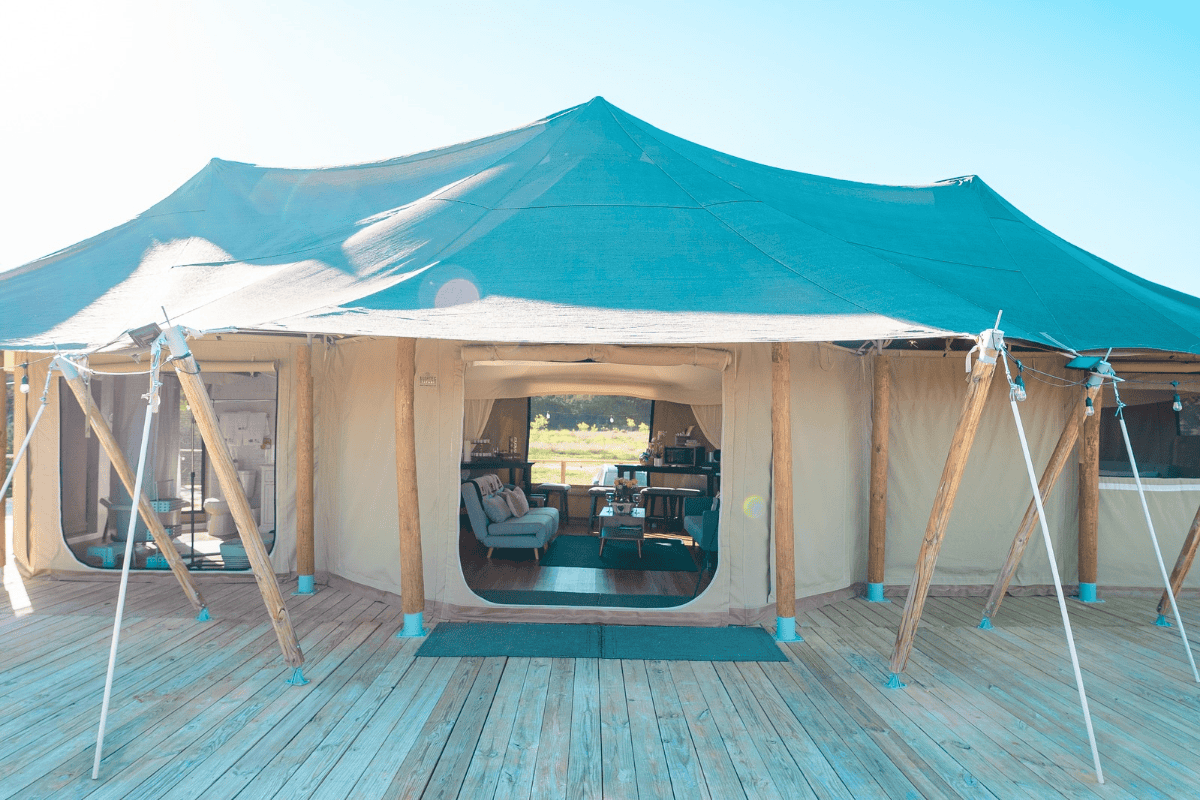 A tent on a wooden platform with a door.