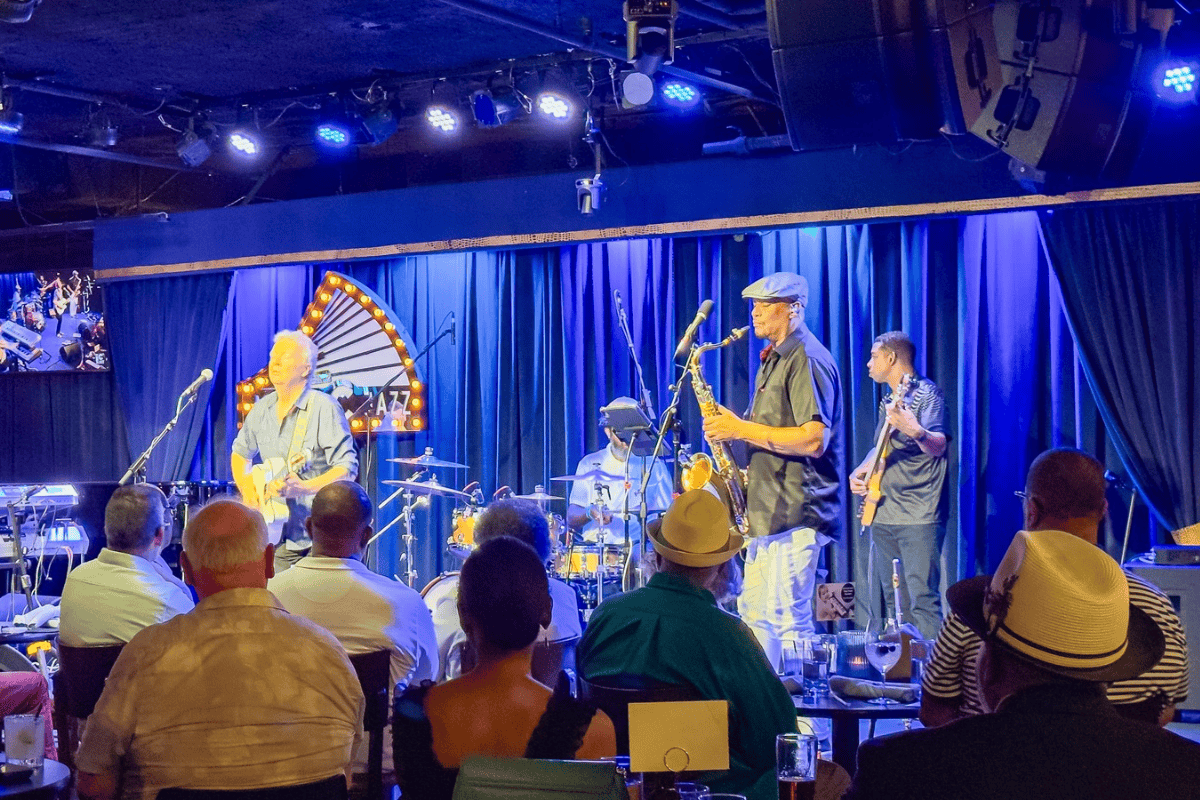 Musicians playing instruments on stage at a jazz club.