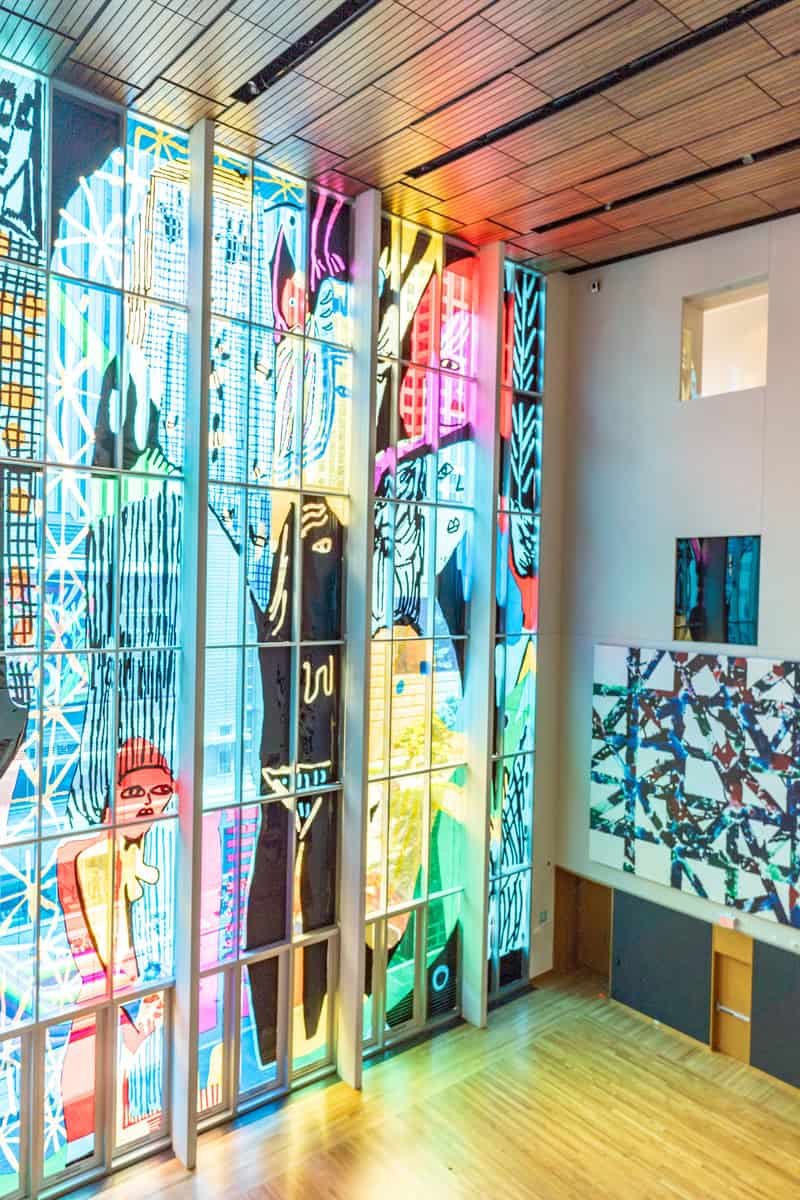 Colorful stained glass windows in a spacious room.