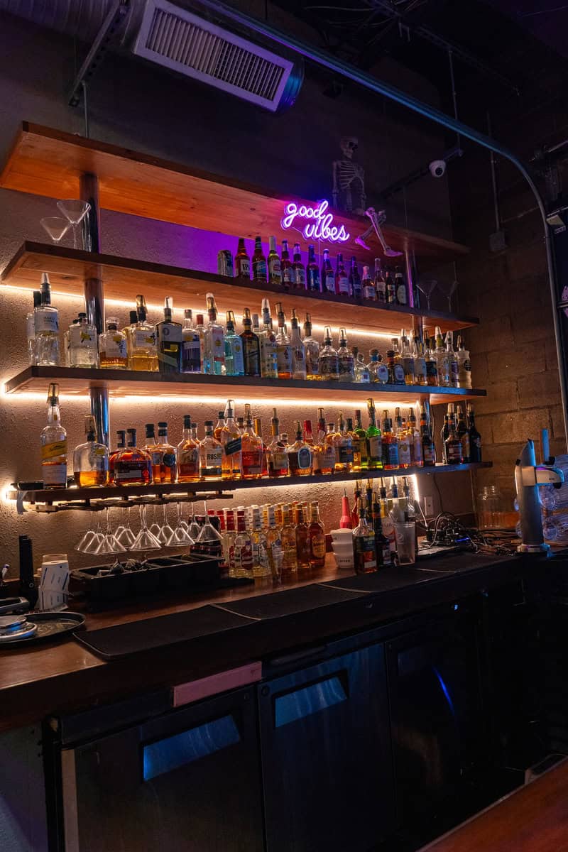 a shelf with bottles of alcohol on it