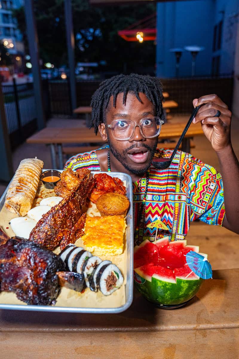 a man holding a spoon and eating food