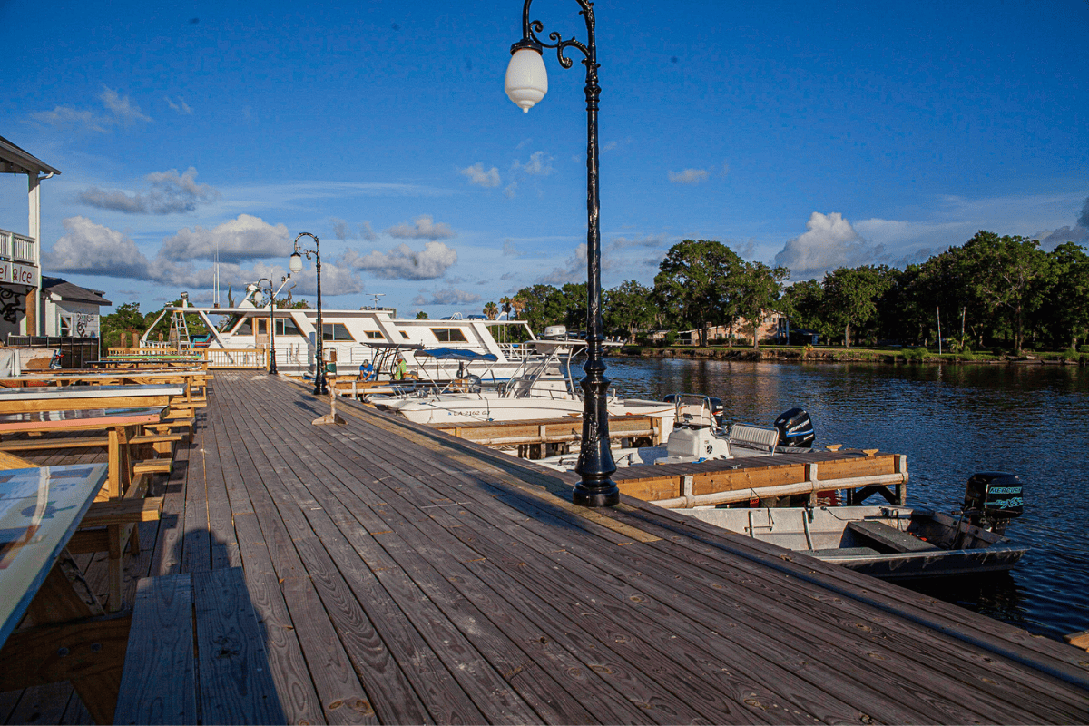 a dock with boats and a lamp post