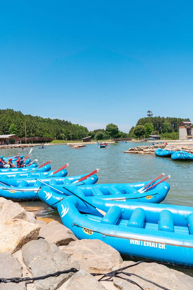 a group of blue rafts on a lake