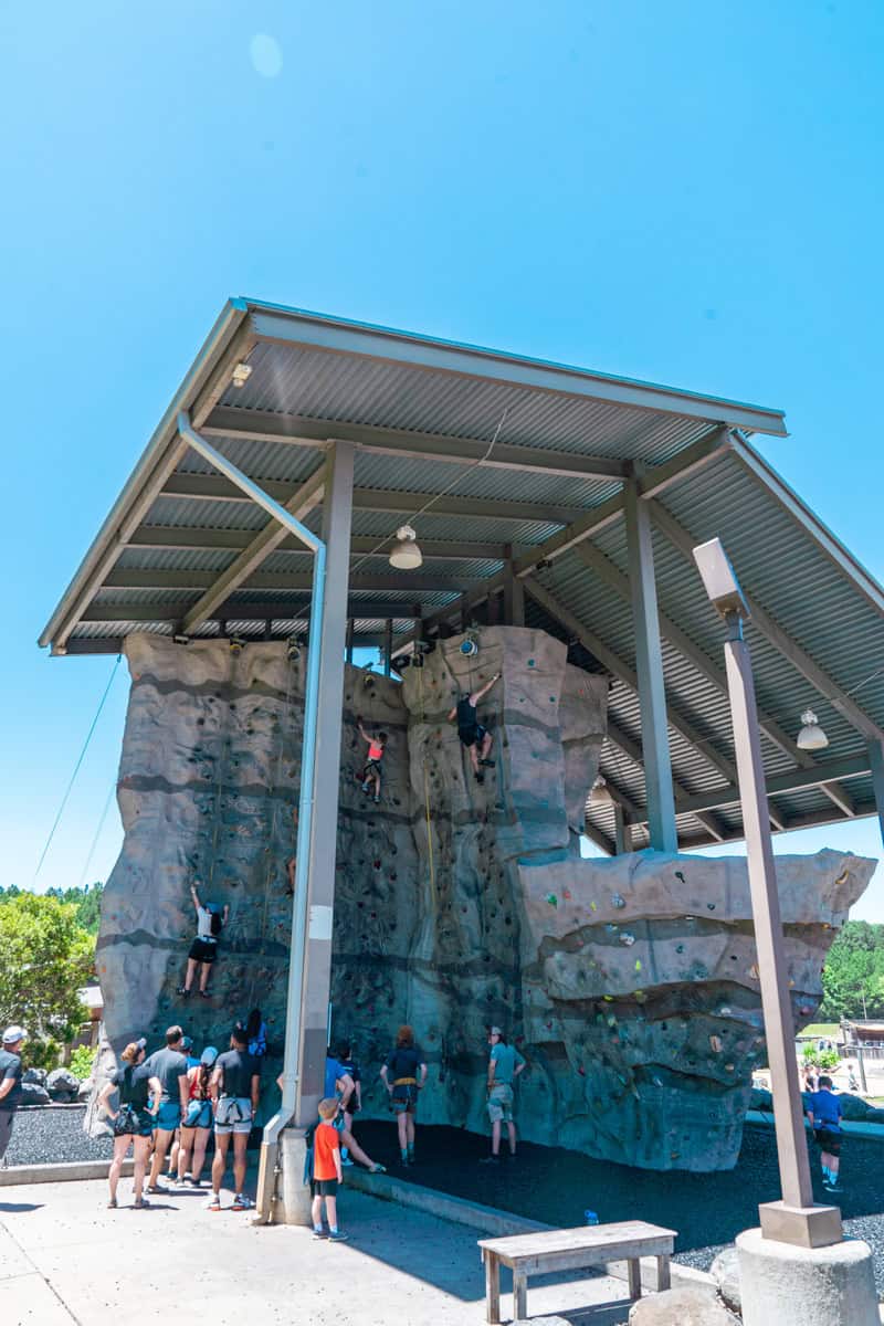 a group of people climbing a rock wall