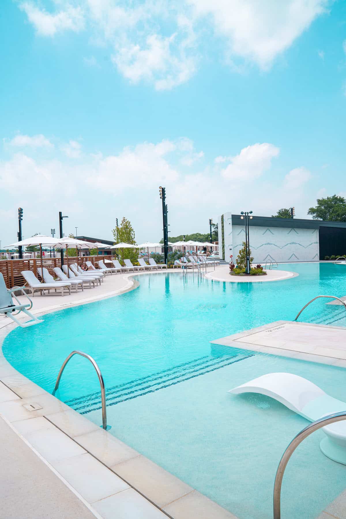 a pool with chairs and umbrellas