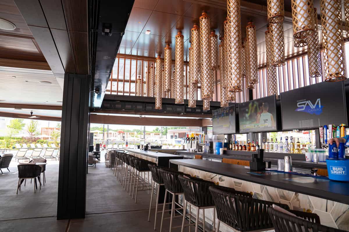 a bar with chairs and a television