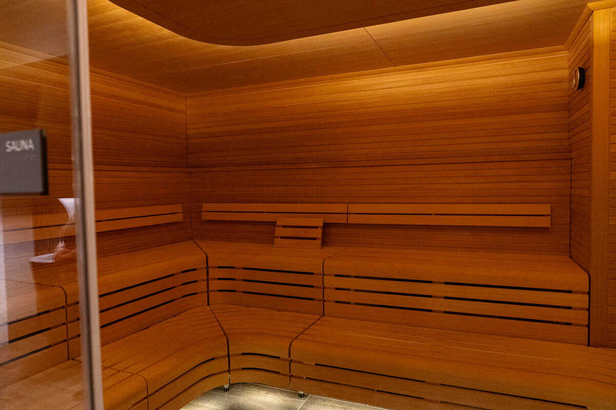 a wooden sauna with a light on the ceiling