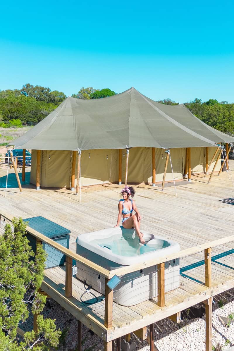 a woman in a garment sitting in a hot tub