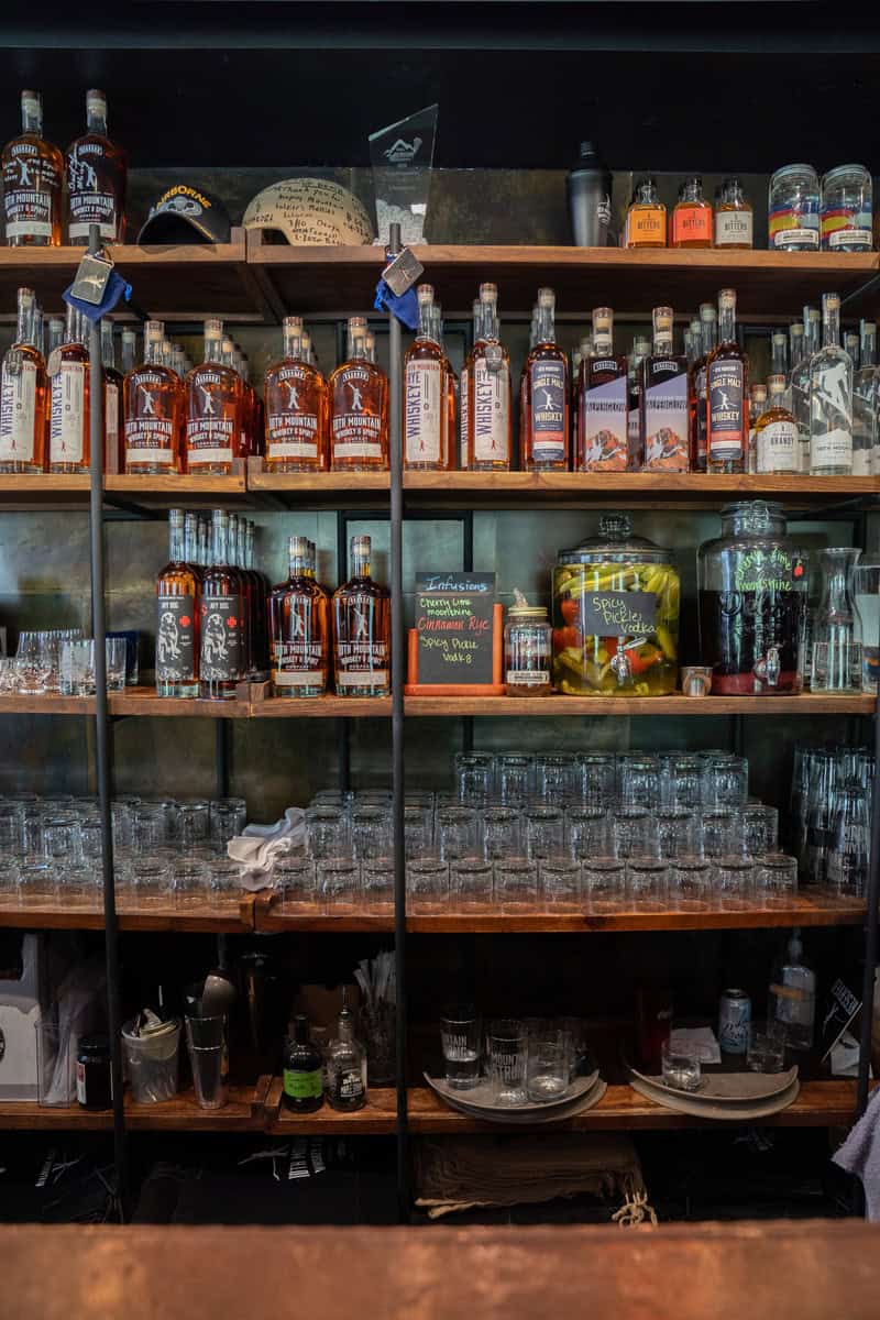 Shelves stocked with assorted whiskey bottles