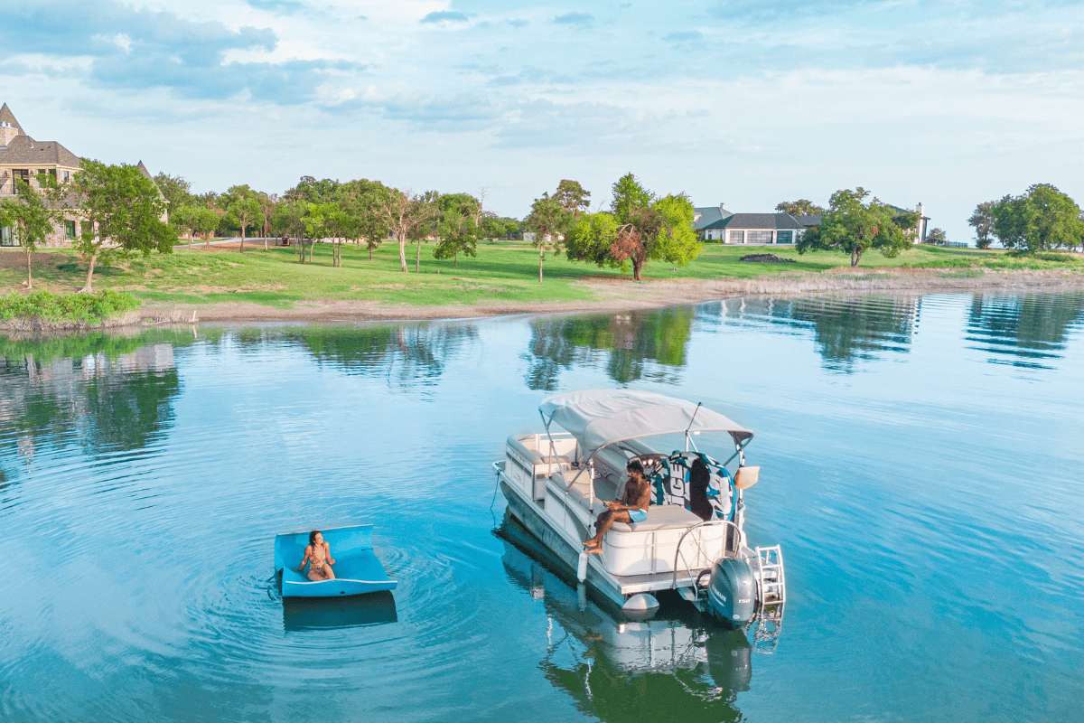 Aerial view of a pontoon boat and a small blue float