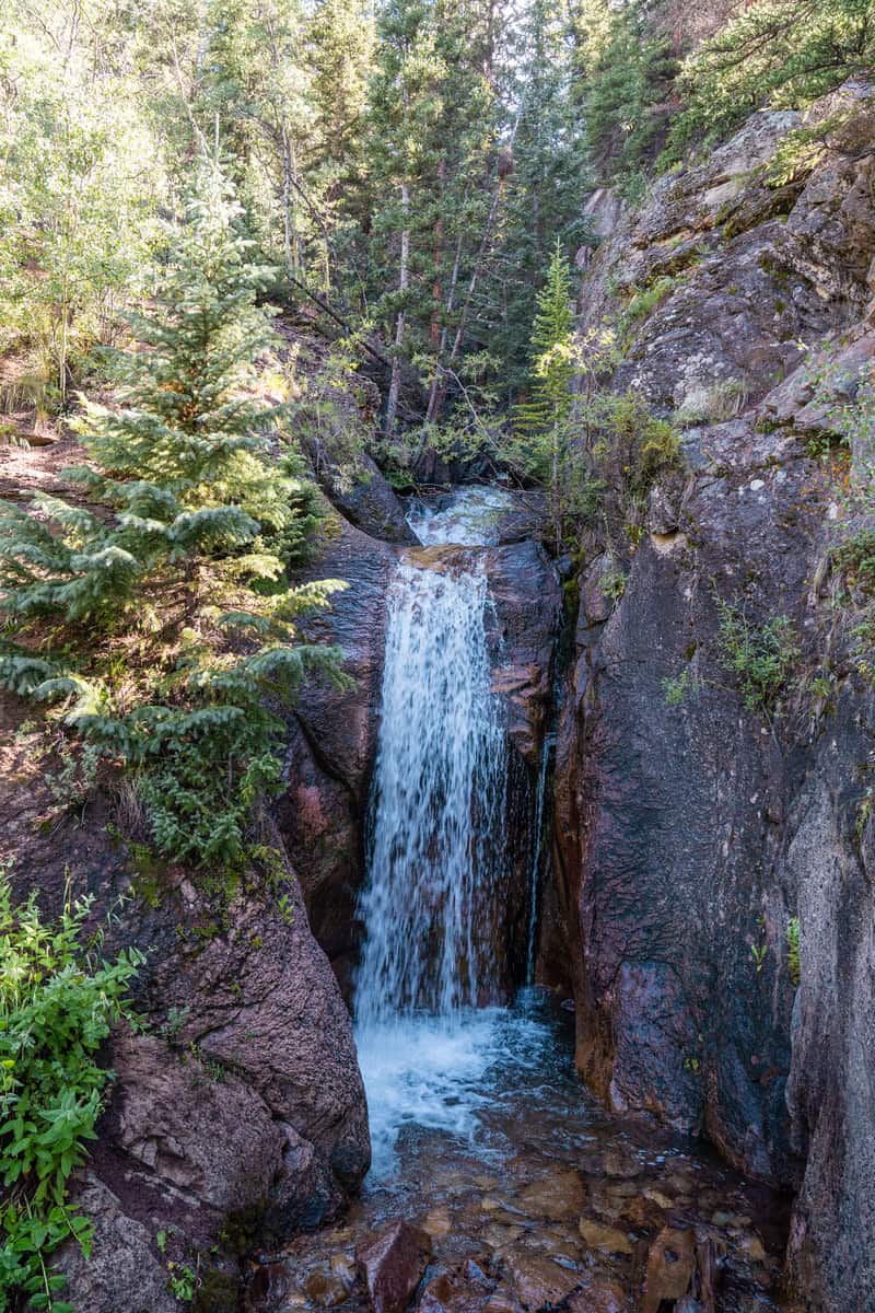 A serene waterfall tucked between rocky cliffs