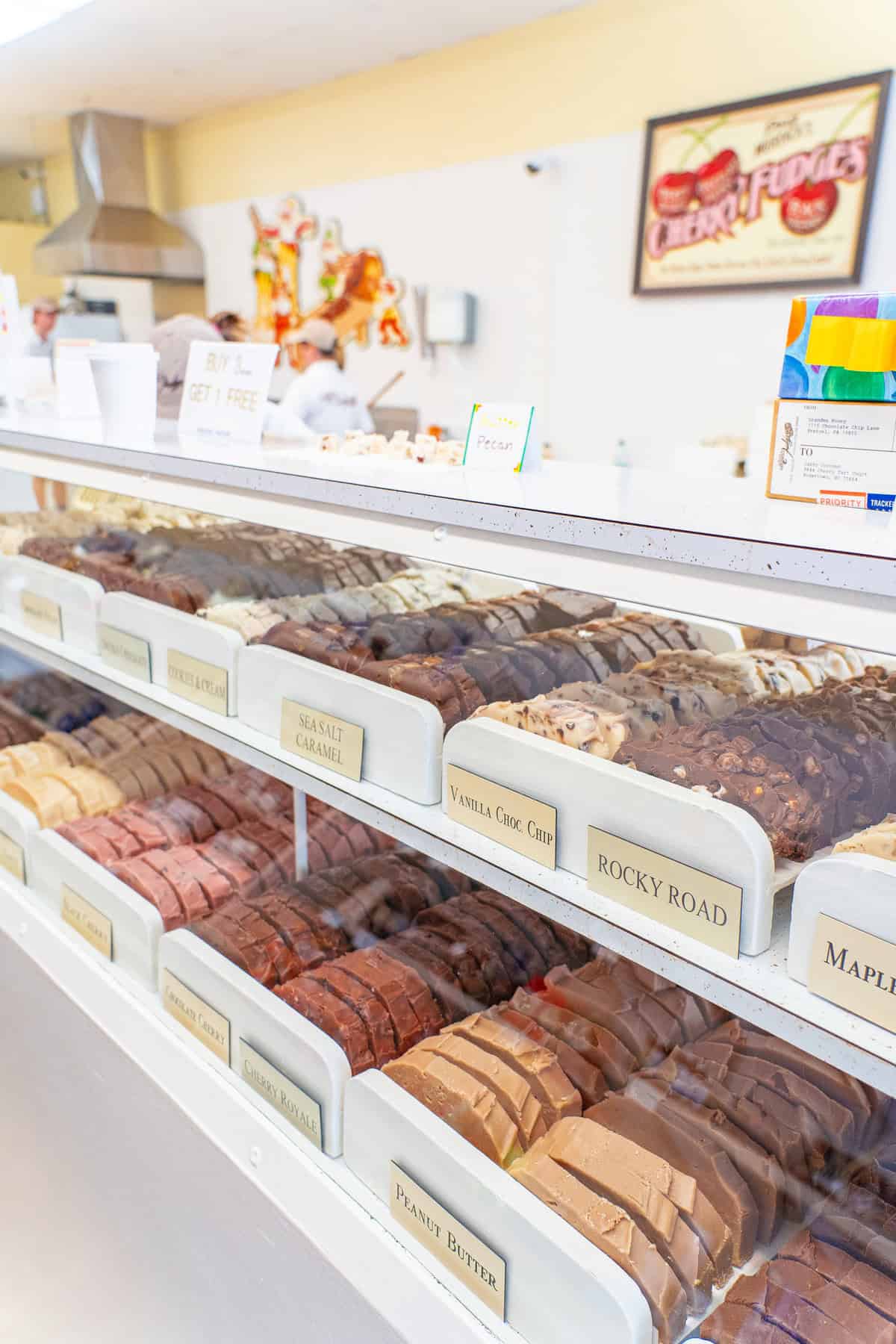 A display case filled with assorted fudge flavors at a sweet shop.