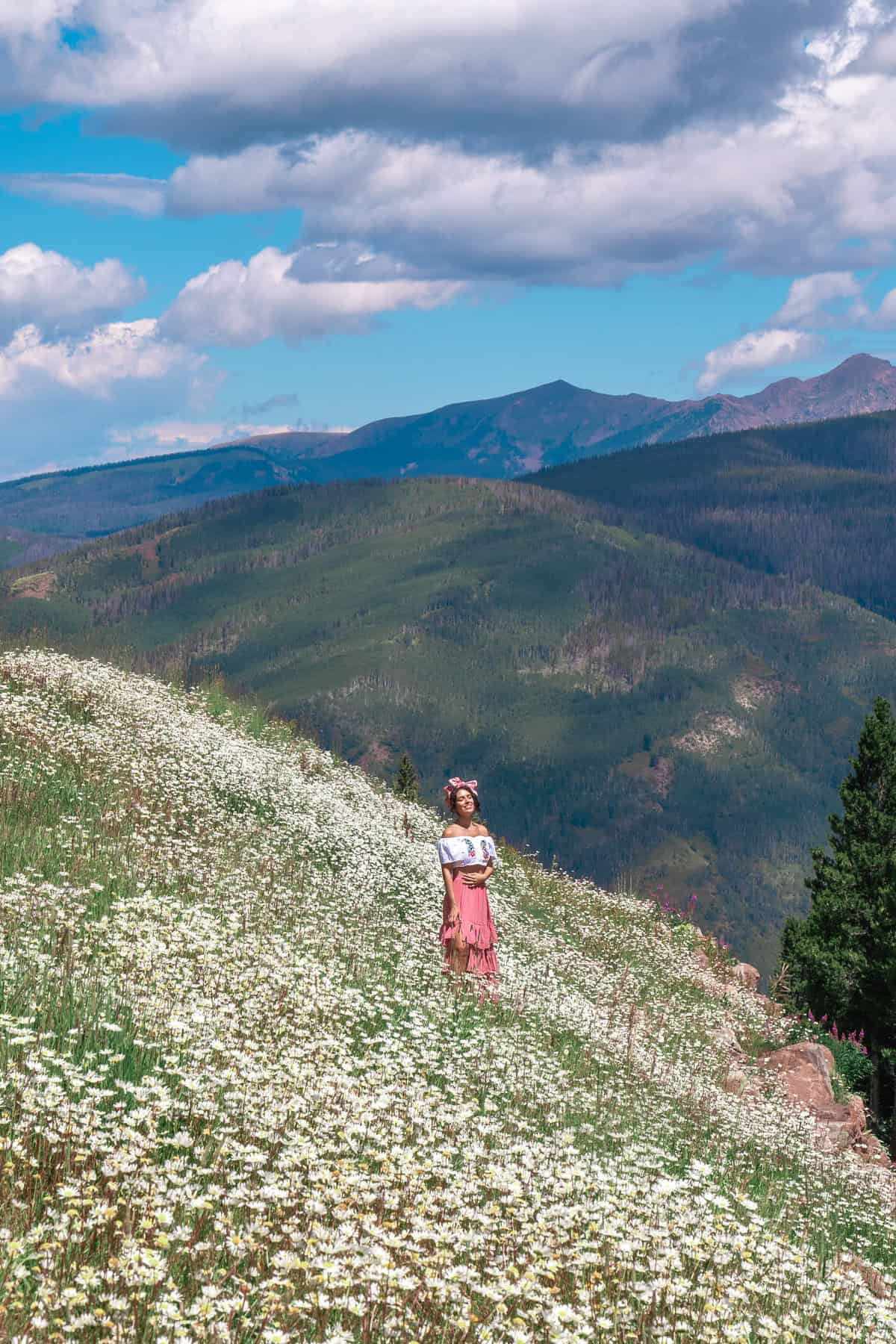 A person standing in a field of white flowers