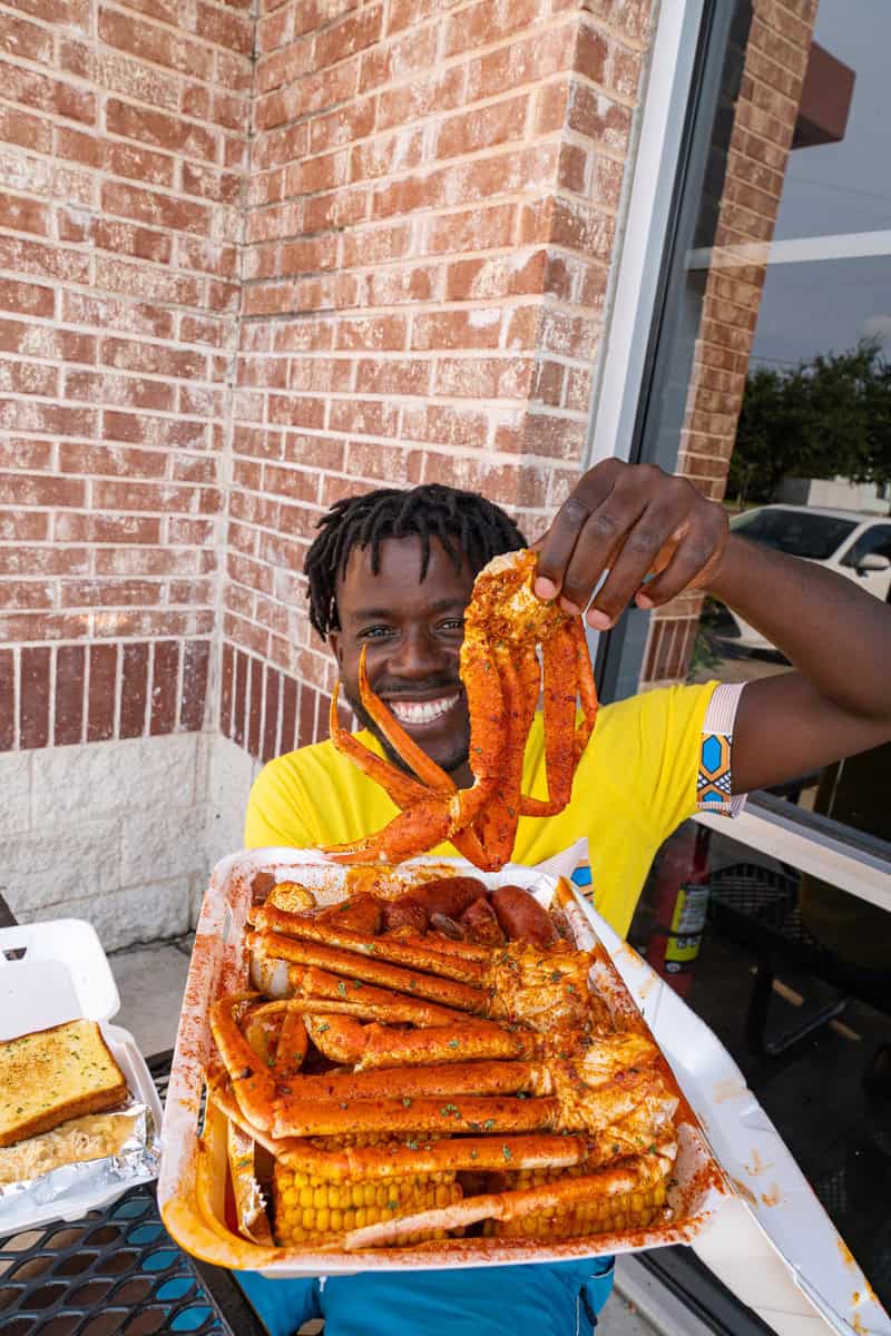 Person holding a crab leg