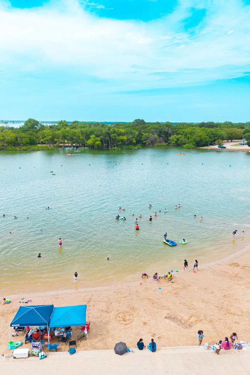 People enjoying a sunny day at a busy beach