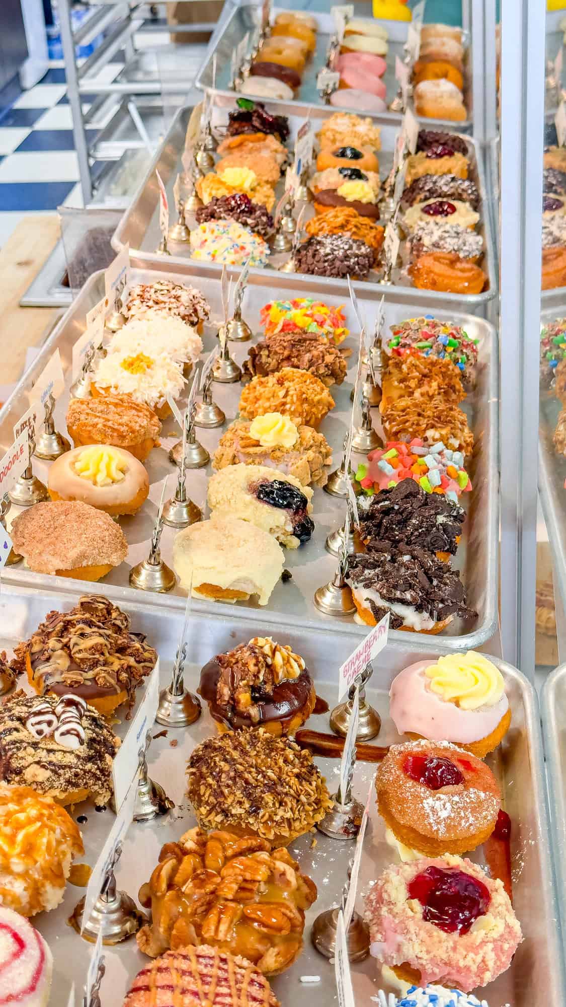 Assorted colorful pastries on display in a bakery case.