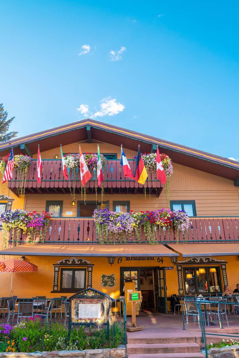 A colorful restaurant front adorned with international flags