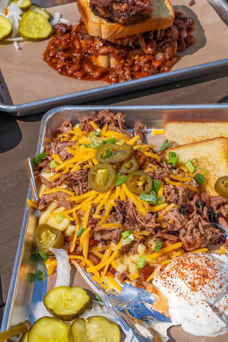 Tray with loaded nachos topped with cheese and jalapeños