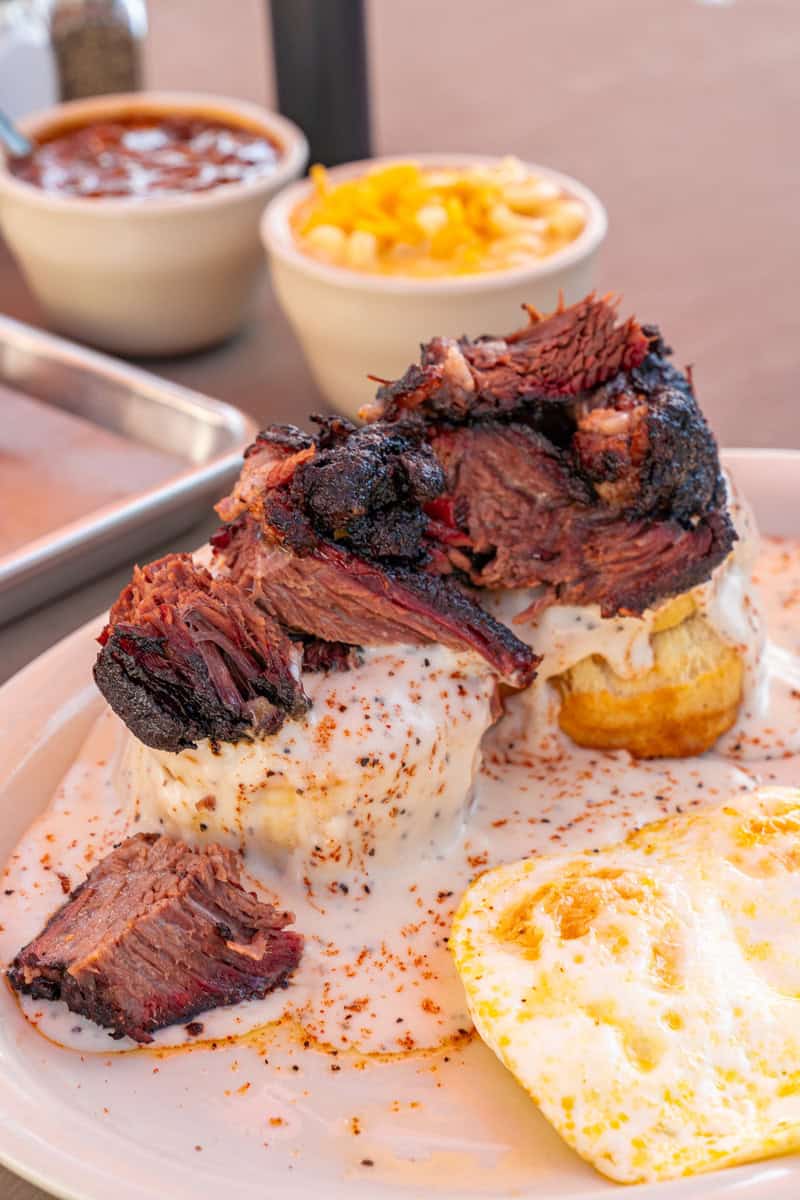 A plate of brisket on a biscuit