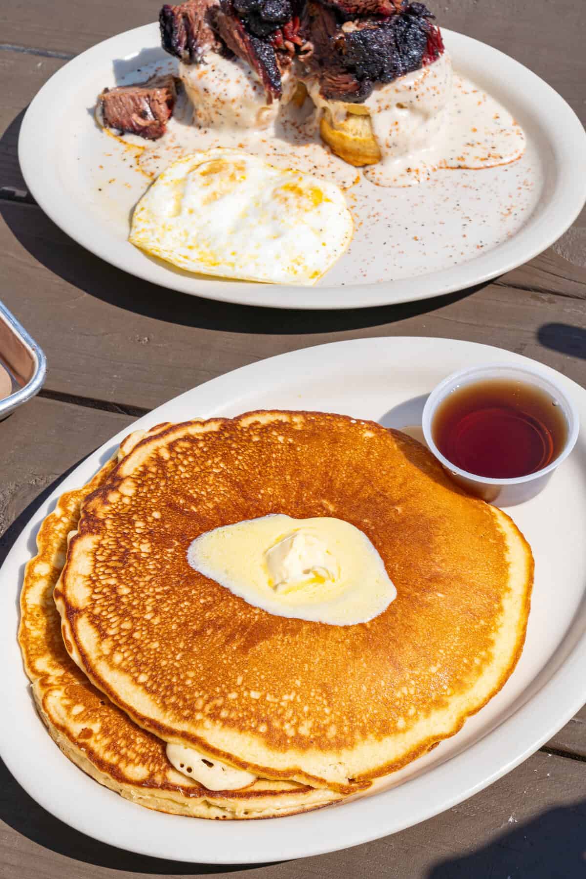 A stack of pancakes with butter and syrup