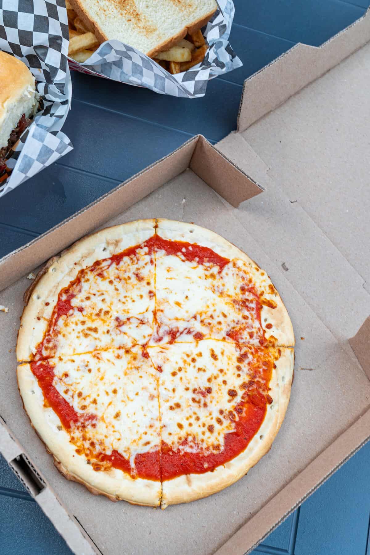 A whole cheese pizza in a box