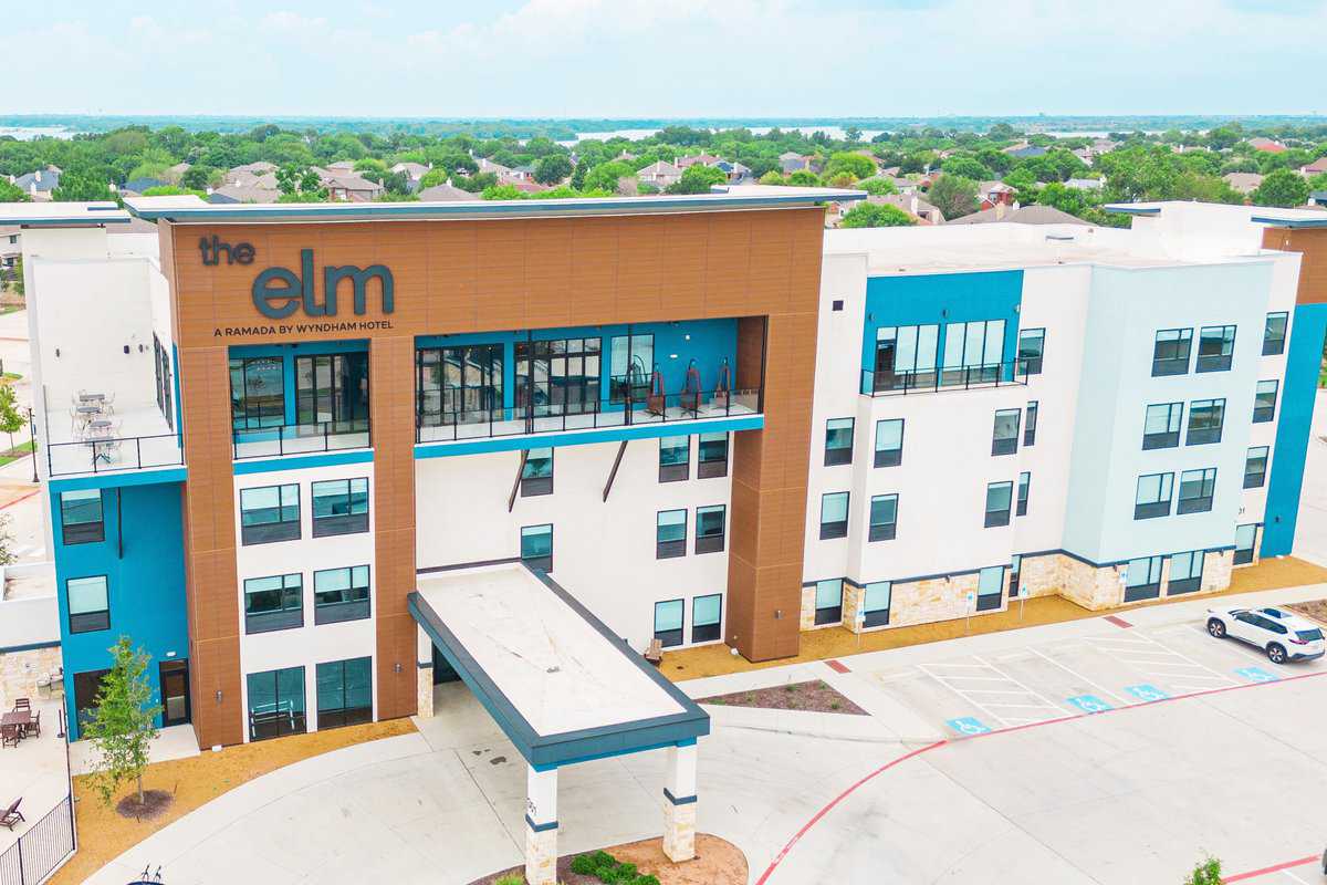 Aerial view of a modern hotel building labeled "the elm,"