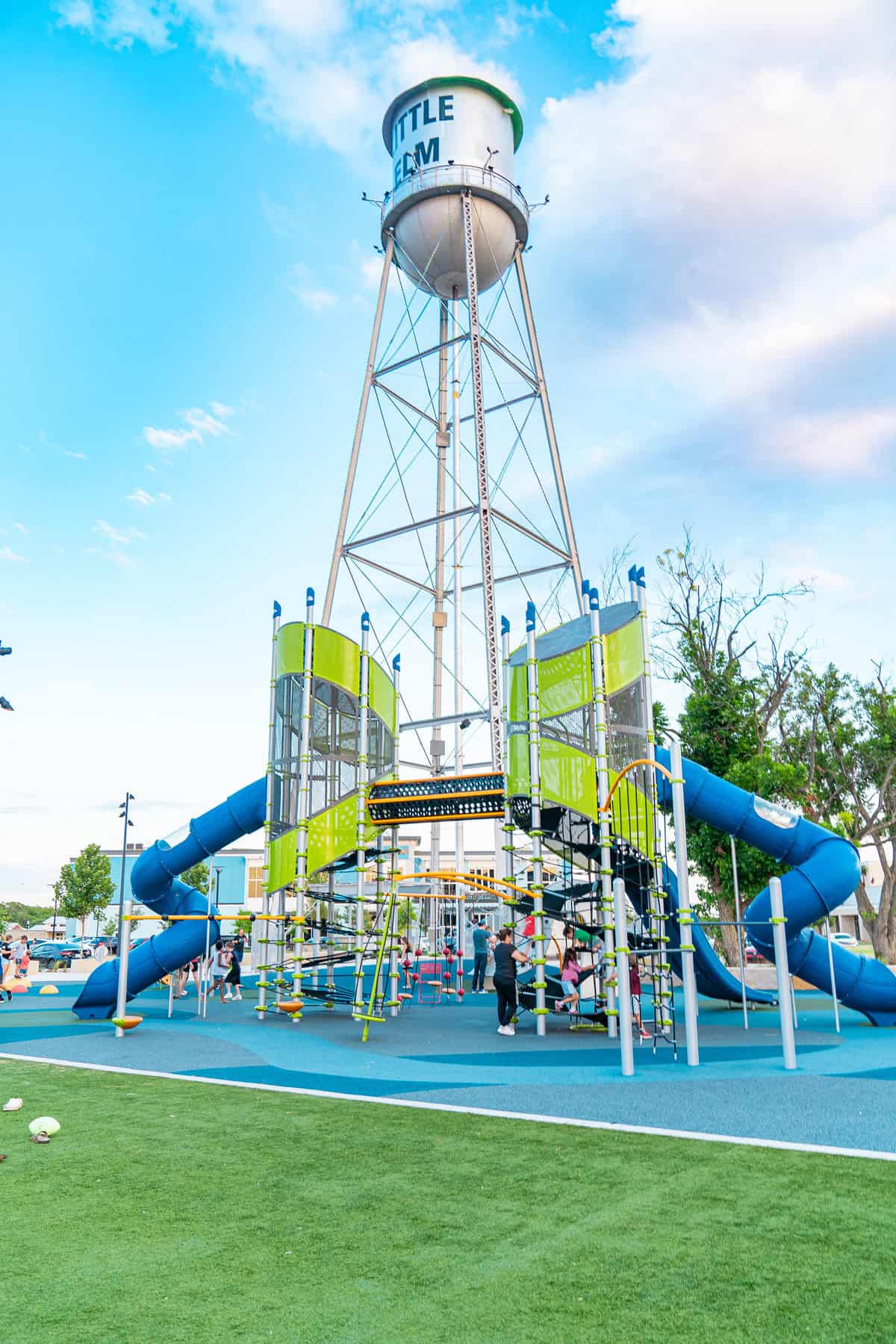 Playground with slides and climbing frames under a water tower