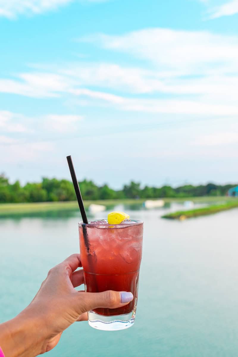 Hand holding a red cocktail