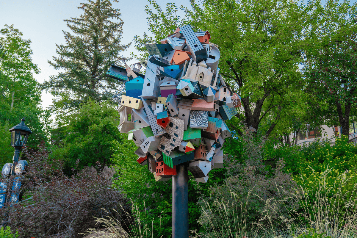 A tree-like structure adorned with colorful birdhouses