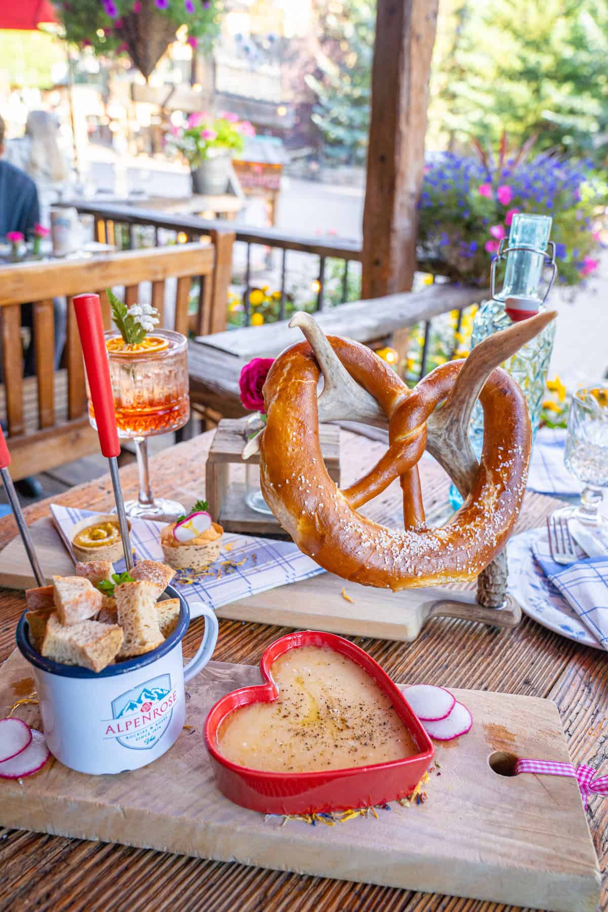 Giant pretzel, heart-shaped cheese dish, and drinks