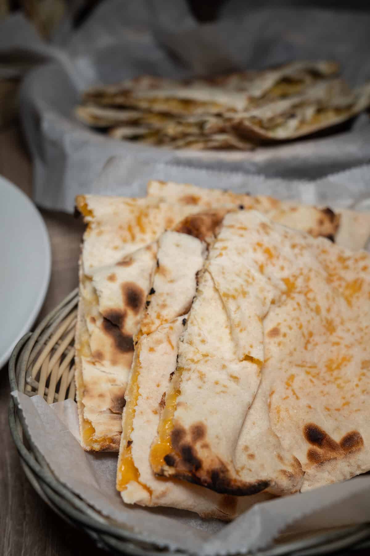 Sliced cheese quesadilla on a woven basket