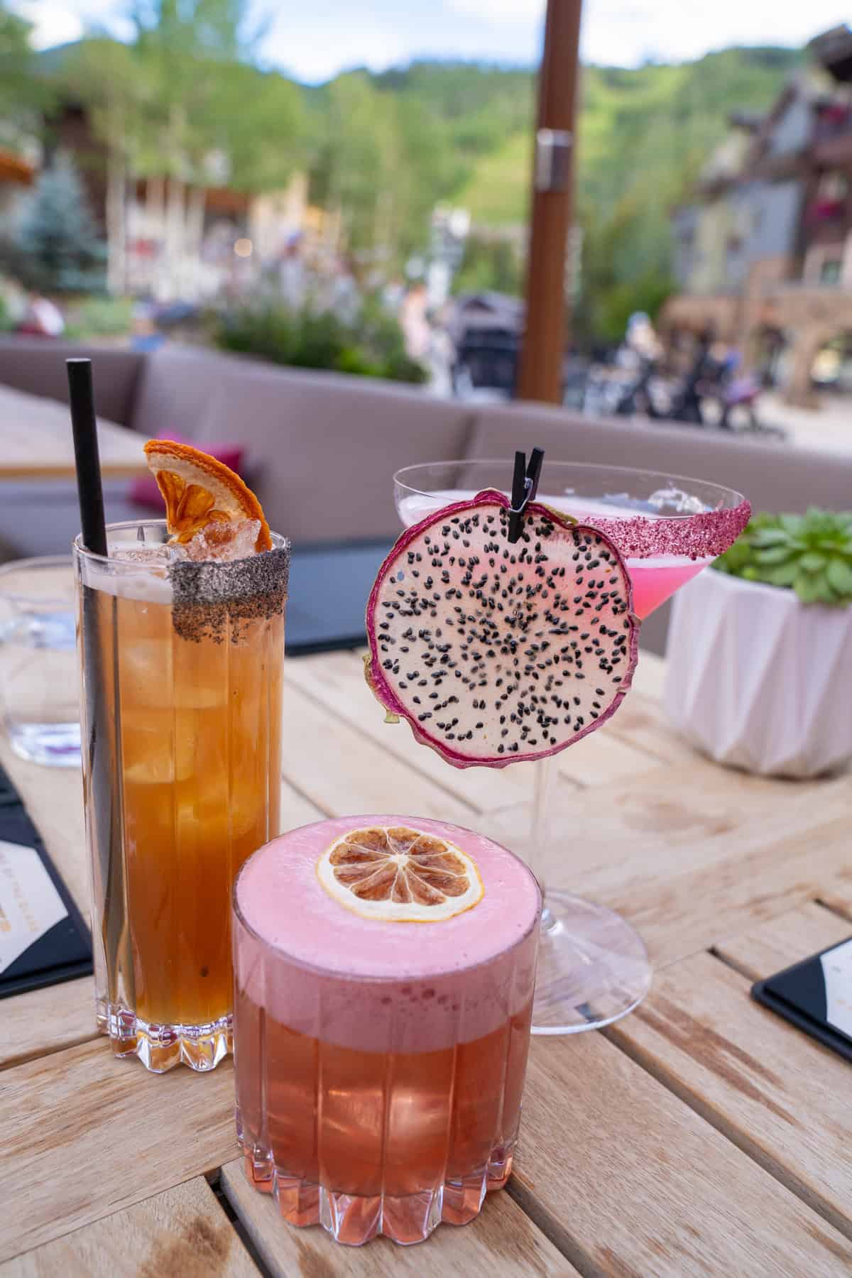 Three fancy cocktails on a table