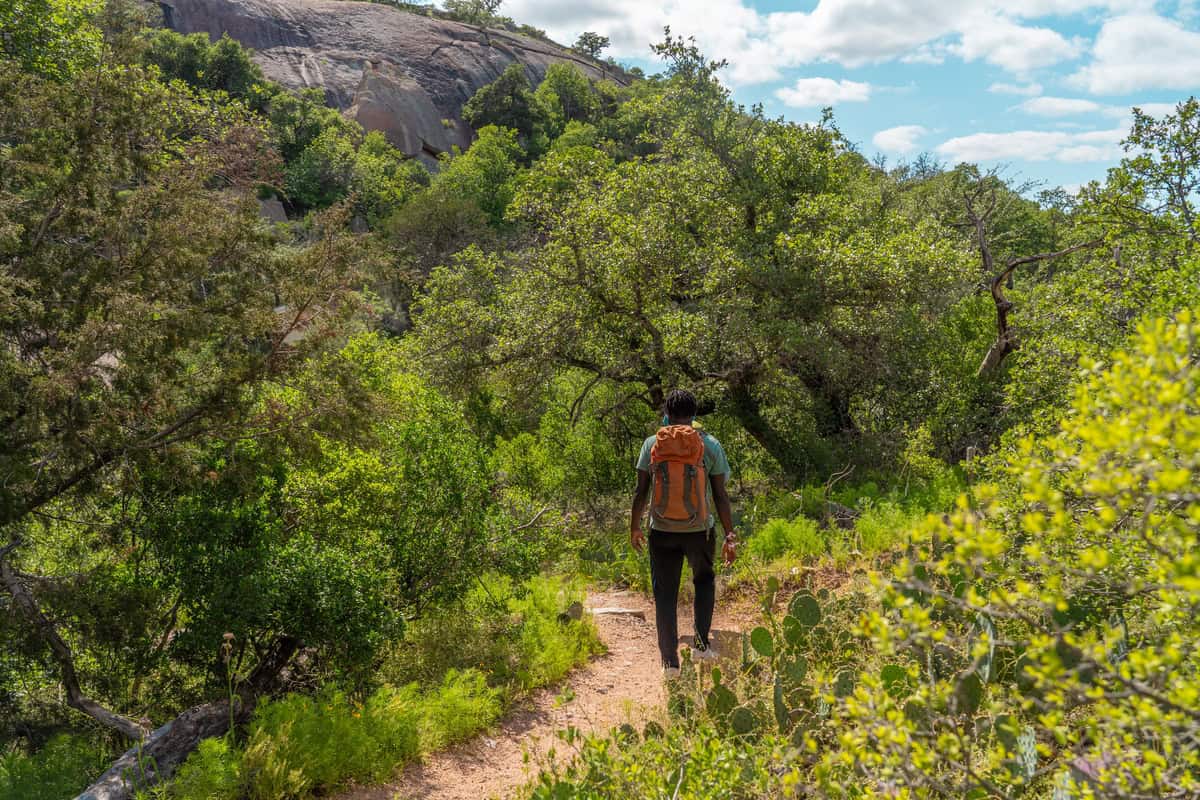 A hiker with an orange backpack