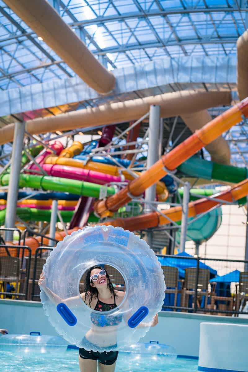 A person holds a transparent inflatable ring in a water park