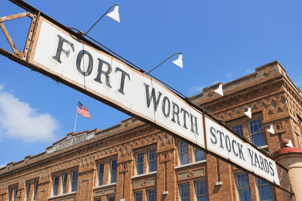 "Sign reading 'Fort Worth Stock Yards' against a blue sky