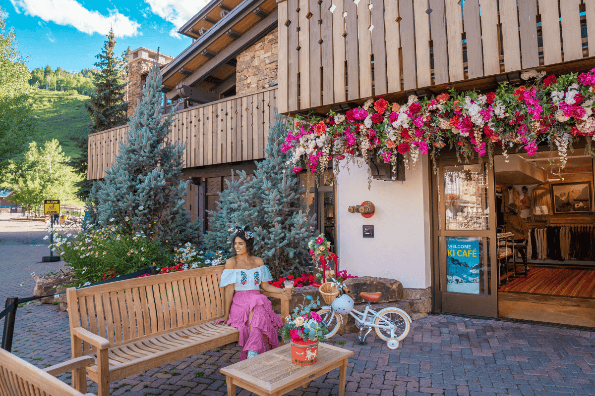 Person sitting on a bench near a cafe adorned