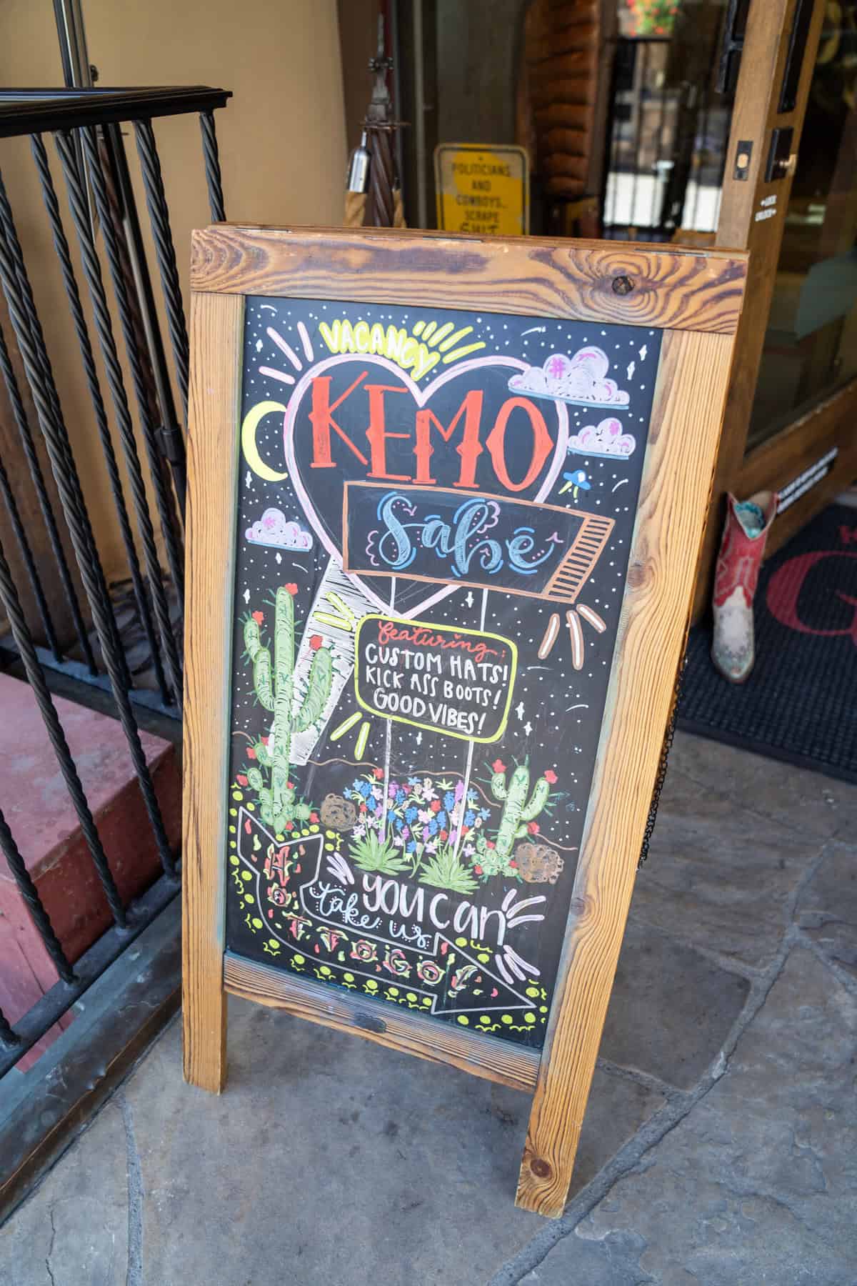 A sandwich board sign advertising "Kemo Sale"