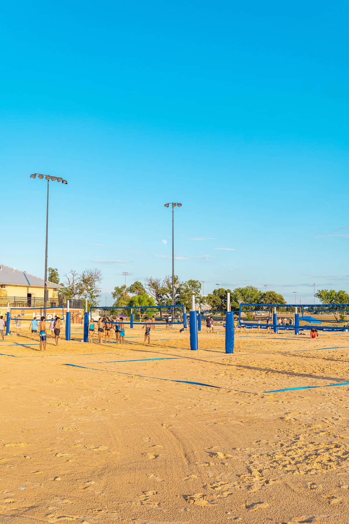 People playing volleyball on an outdoor sand court