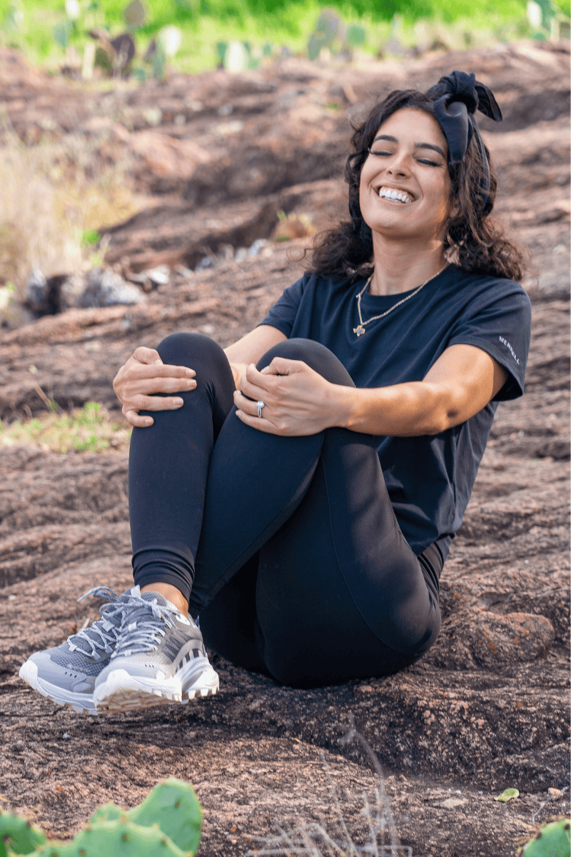 Person sitting on rocky ground outdoors