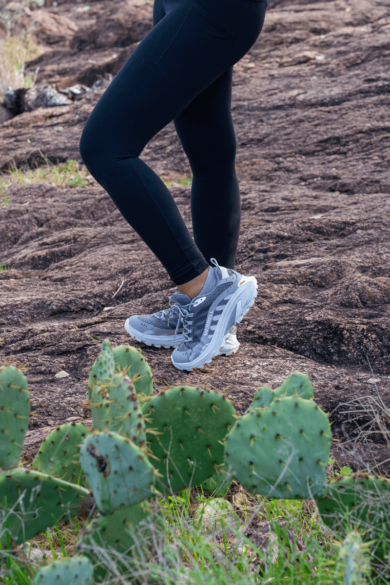 Person in athletic wear standing on a trail