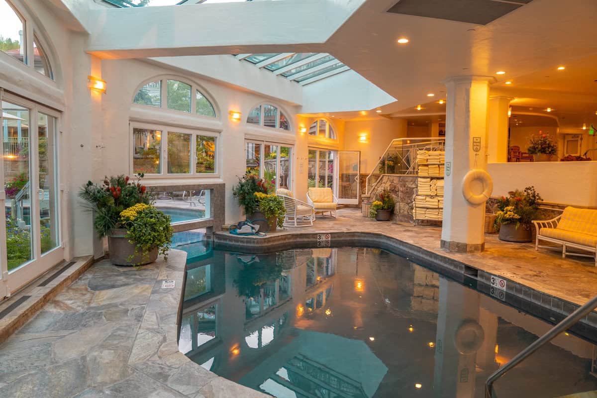 Indoor pool with arched windows and skylights