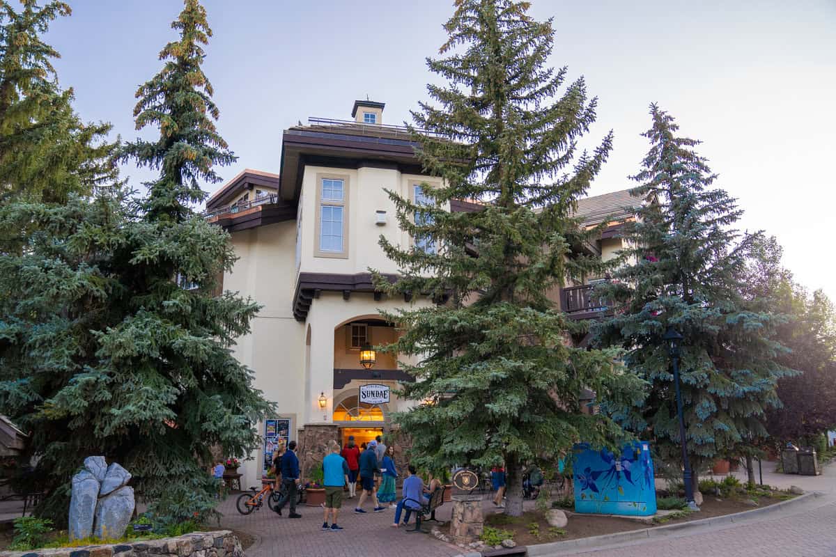 People gather outside a quaint building