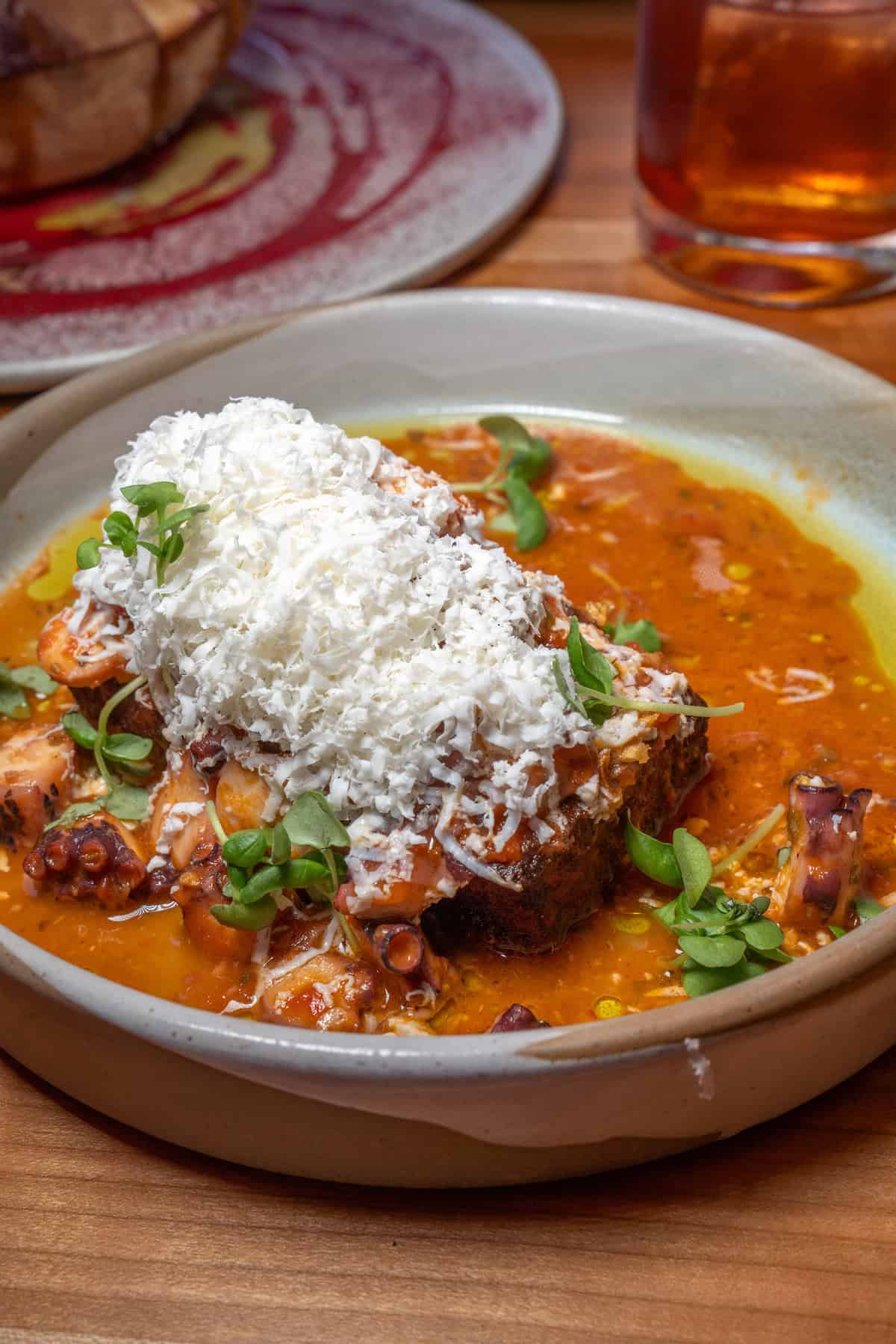 A plate of stewed octopus with tomato sauce