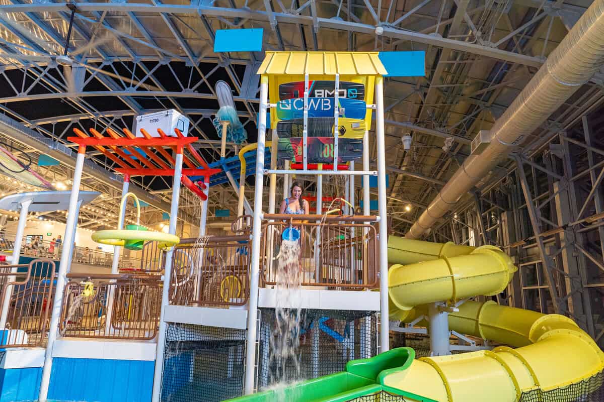 Indoor water park with colorful slides and play structures.