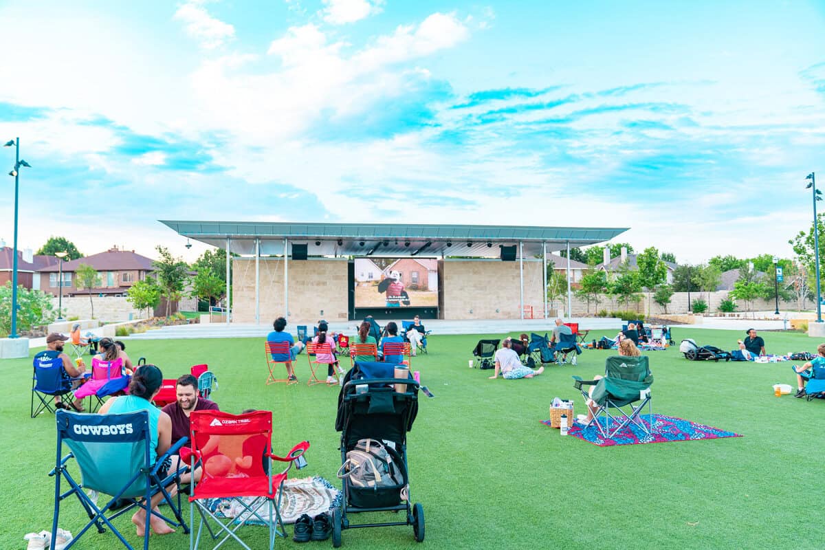 People on a lawn watching a movie