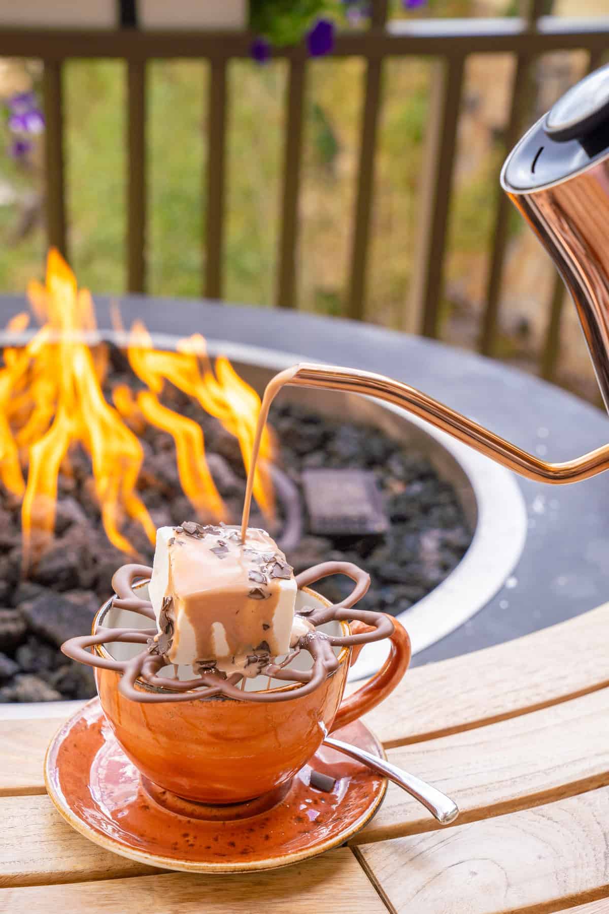 A melting hot chocolate bomb in a cup