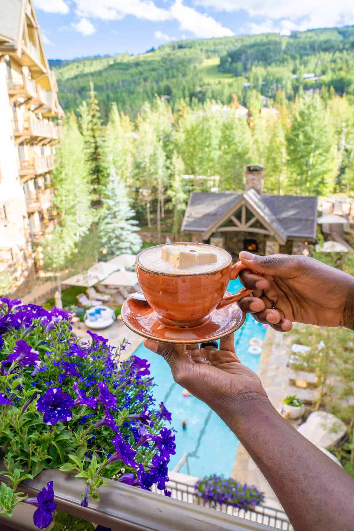 A hand holding a cup of coffee